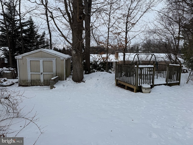 snowy yard with a deck