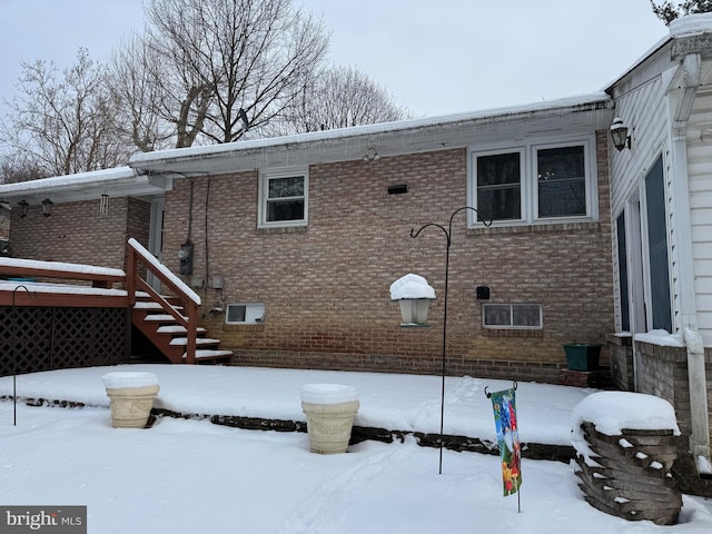 view of snow covered rear of property