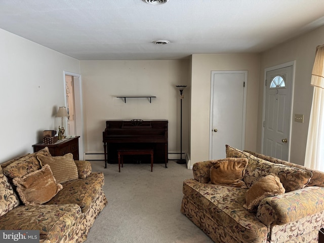 carpeted living room with a baseboard heating unit