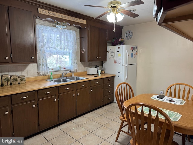 kitchen featuring dark brown cabinets and sink