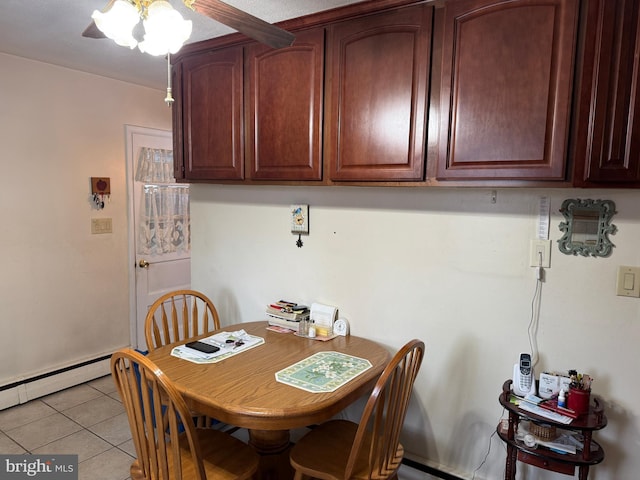 tiled dining area with a baseboard radiator and ceiling fan