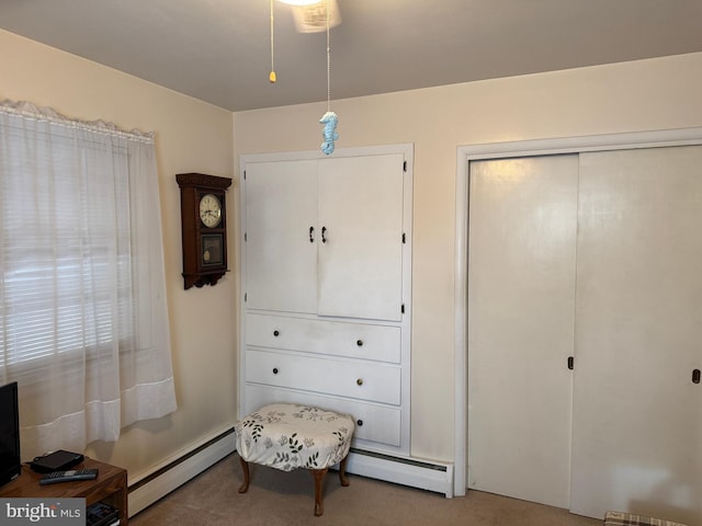 interior space featuring a baseboard radiator and carpet flooring