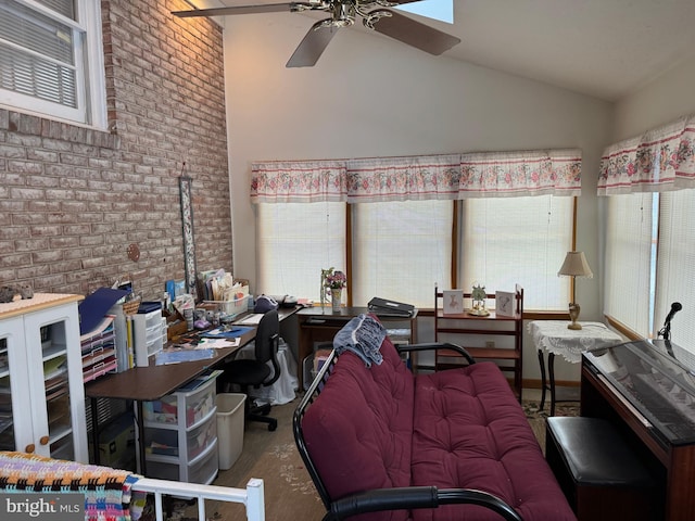 interior space featuring ceiling fan, brick wall, and vaulted ceiling