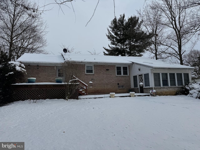 view of snow covered back of property