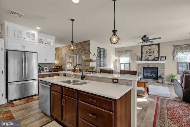 kitchen featuring pendant lighting, sink, a healthy amount of sunlight, and appliances with stainless steel finishes