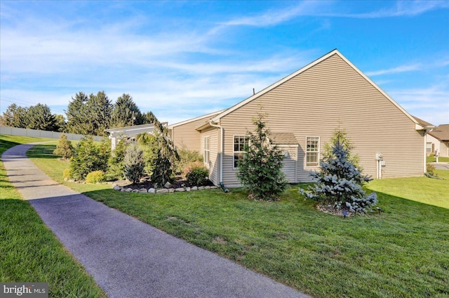 view of side of home featuring a lawn