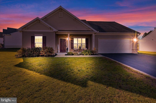 craftsman house featuring a garage and a lawn