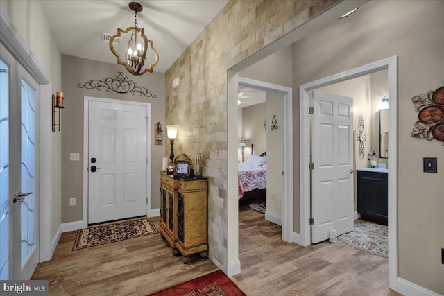 foyer with a chandelier and light hardwood / wood-style flooring