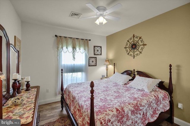 bedroom with ceiling fan and dark hardwood / wood-style flooring