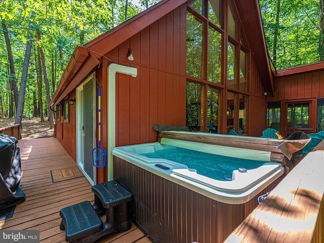 wooden terrace with a hot tub