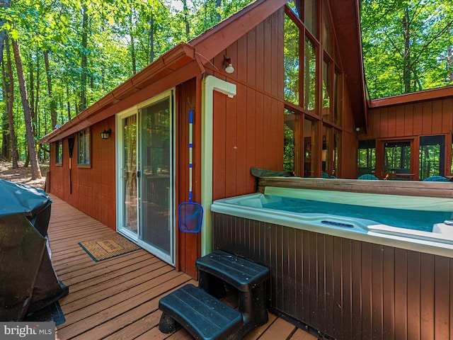 wooden terrace with a hot tub