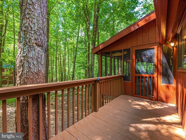 wooden deck with a sunroom