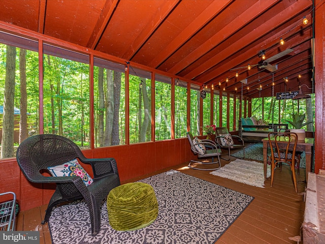 sunroom / solarium featuring vaulted ceiling