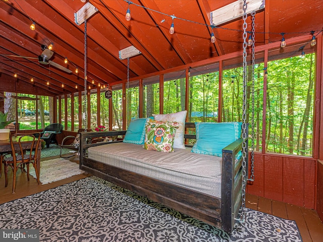 sunroom / solarium featuring lofted ceiling