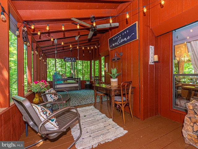 sunroom / solarium featuring ceiling fan