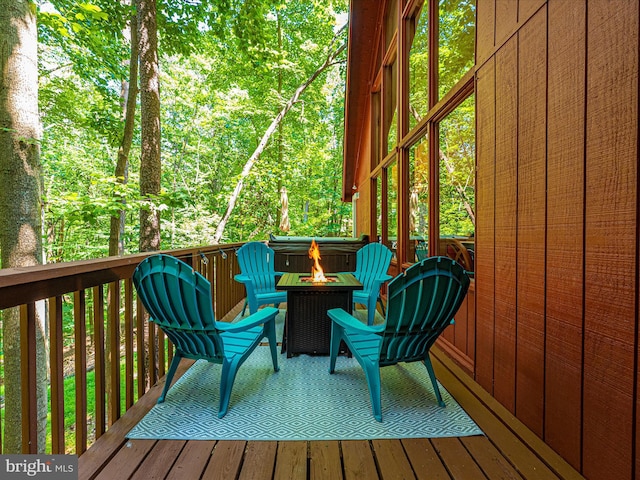 wooden terrace with an outdoor fire pit