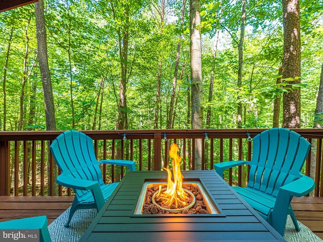 wooden terrace with a fire pit