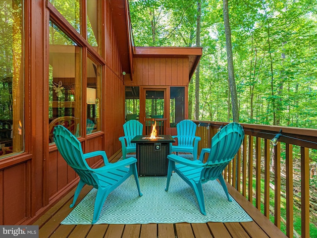 wooden deck featuring a fire pit