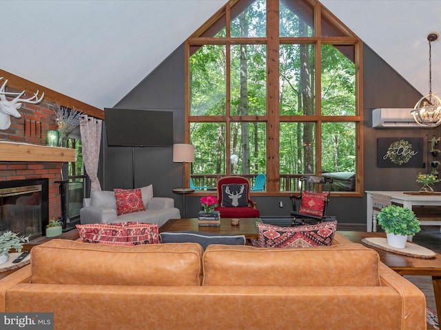 living room with an AC wall unit, high vaulted ceiling, a notable chandelier, and a fireplace