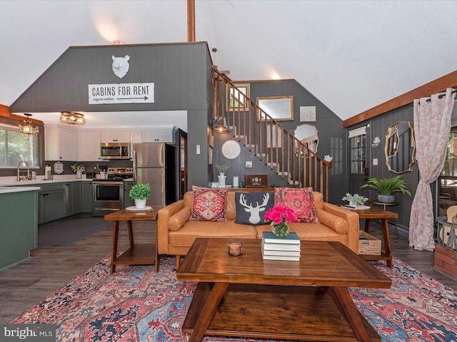 living room featuring high vaulted ceiling and dark hardwood / wood-style flooring