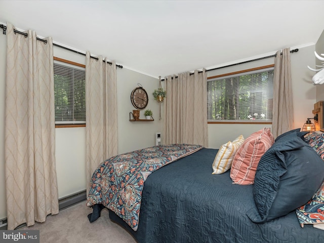 bedroom featuring a baseboard heating unit and light carpet