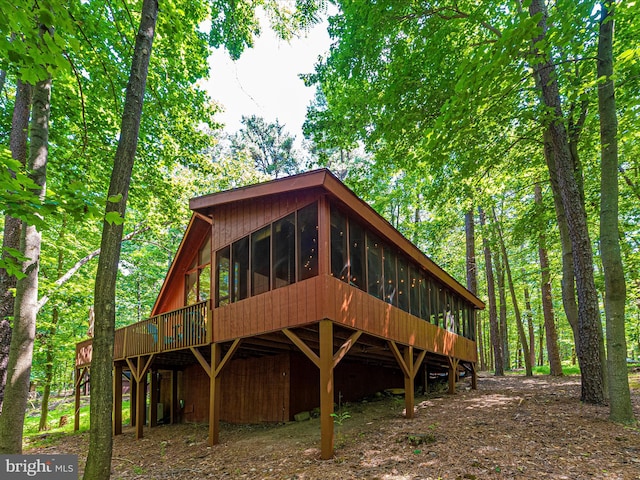 exterior space featuring a sunroom and a deck