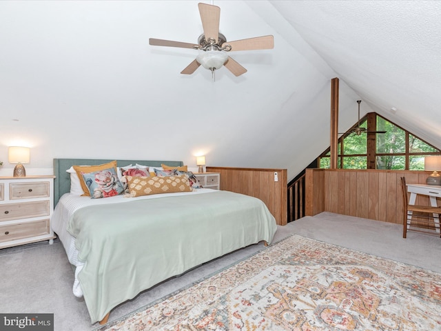 bedroom featuring vaulted ceiling, carpet, and wood walls