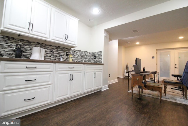 bar with white cabinets, french doors, decorative backsplash, and dark hardwood / wood-style flooring