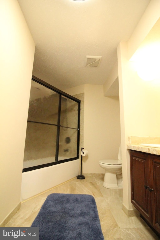 full bathroom featuring vanity, toilet, and combined bath / shower with glass door