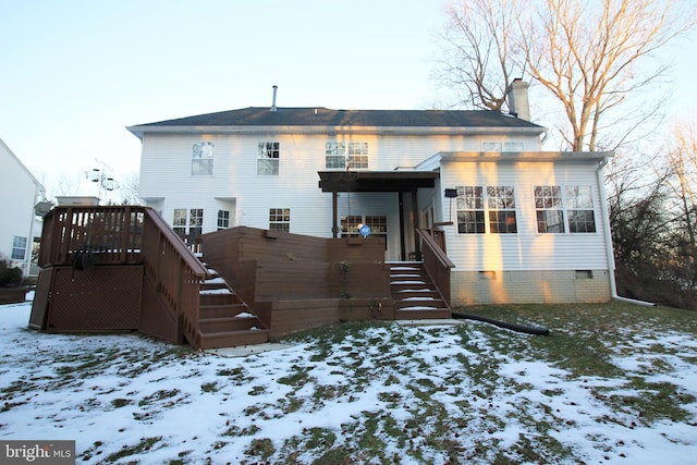 view of snow covered rear of property