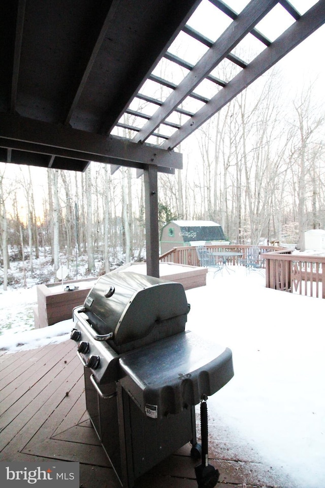 snow covered deck with a pergola, grilling area, and a hot tub