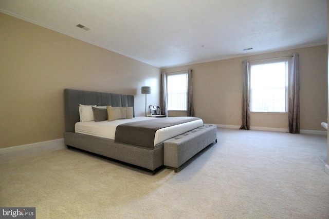 bedroom featuring crown molding and light carpet