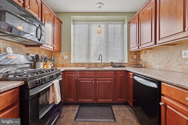 kitchen with sink, backsplash, hanging light fixtures, black appliances, and light stone countertops