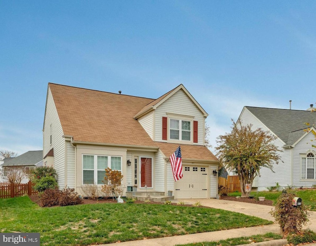 view of front of house with a garage and a front lawn