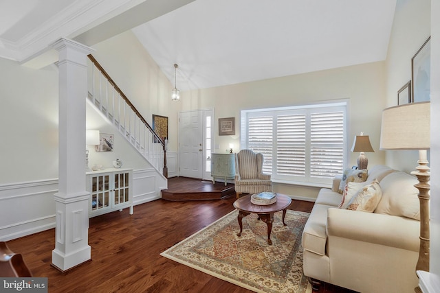 living room with vaulted ceiling, decorative columns, and dark hardwood / wood-style floors