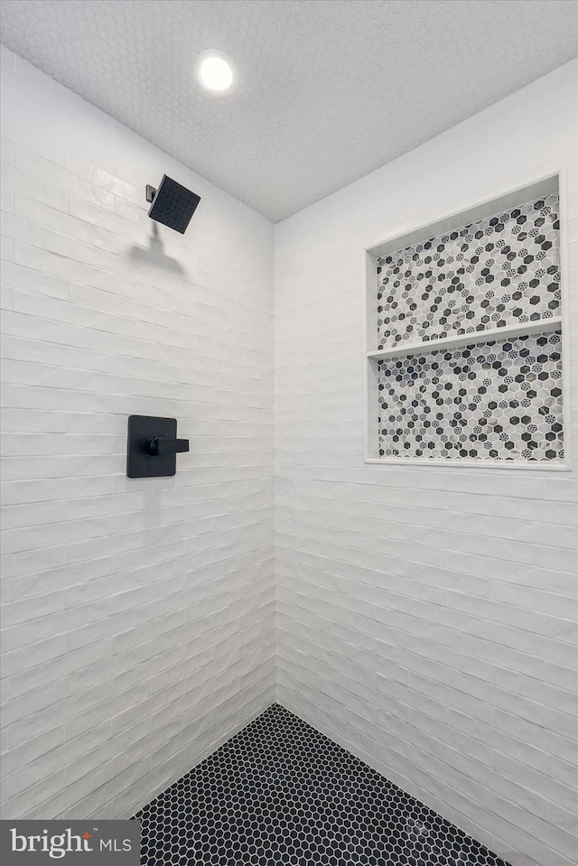 bathroom with tiled shower