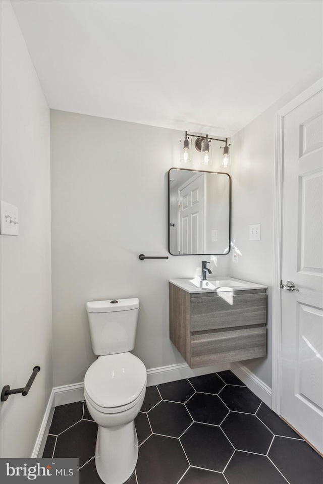 bathroom featuring toilet, tile patterned floors, and vanity