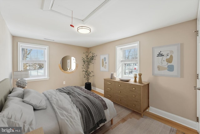 bedroom featuring light hardwood / wood-style floors and multiple windows