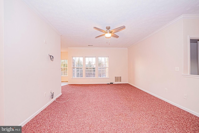 spare room with ceiling fan, a textured ceiling, carpet, and ornamental molding