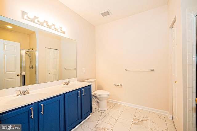 bathroom featuring vanity, toilet, and a shower with door