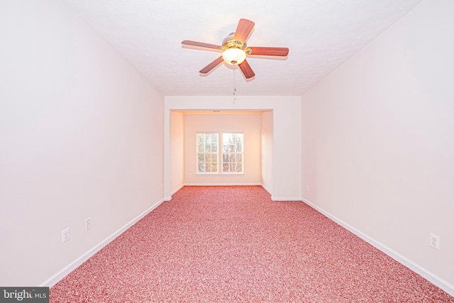 unfurnished room featuring ceiling fan, light colored carpet, and a textured ceiling