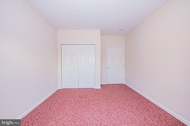 unfurnished bedroom featuring carpet floors and a closet