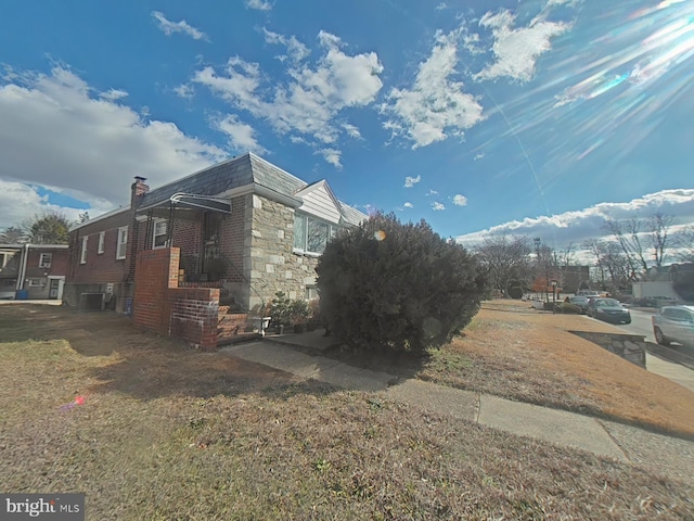 view of side of property with a lawn