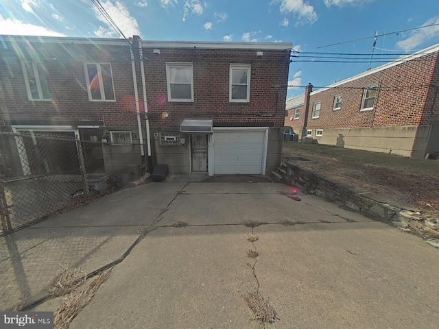 back of property featuring a garage