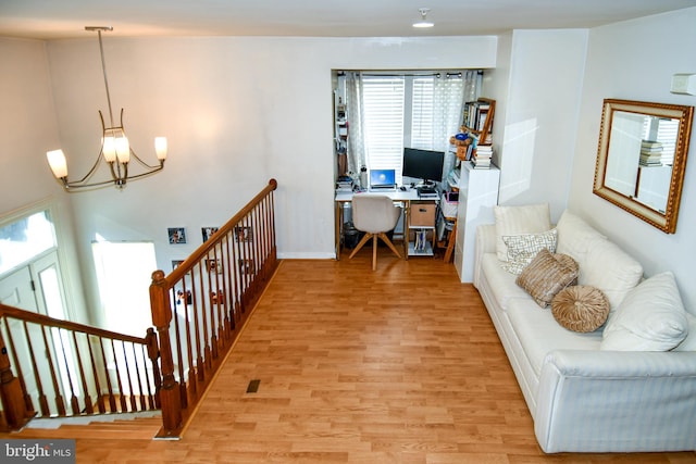 office featuring a notable chandelier and light hardwood / wood-style flooring