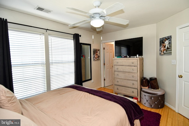 bedroom with ceiling fan and light hardwood / wood-style flooring