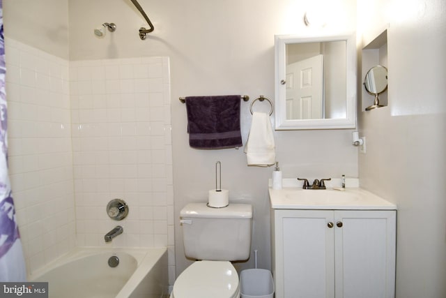 full bathroom with tiled shower / bath combo, vanity, and toilet