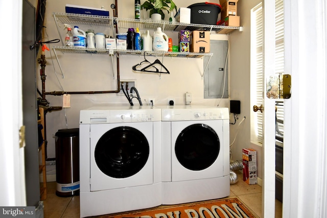 laundry area featuring washer and clothes dryer and light tile patterned flooring