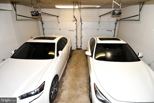 garage with a garage door opener and washer and clothes dryer