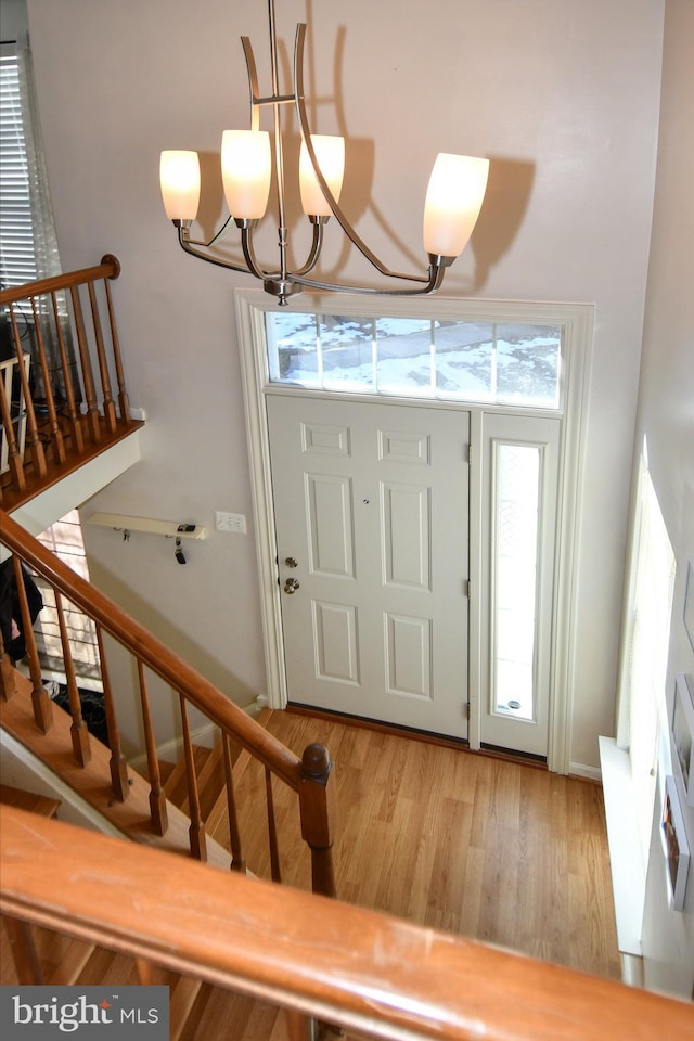 foyer featuring an inviting chandelier and hardwood / wood-style floors